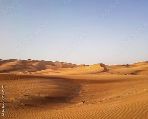 Landscape of desert in Dubai  sand dunes which lack of water and vegetation in hot weather under the blue sky in daylight  and rapid temperature change between day and night when darkness revisited.