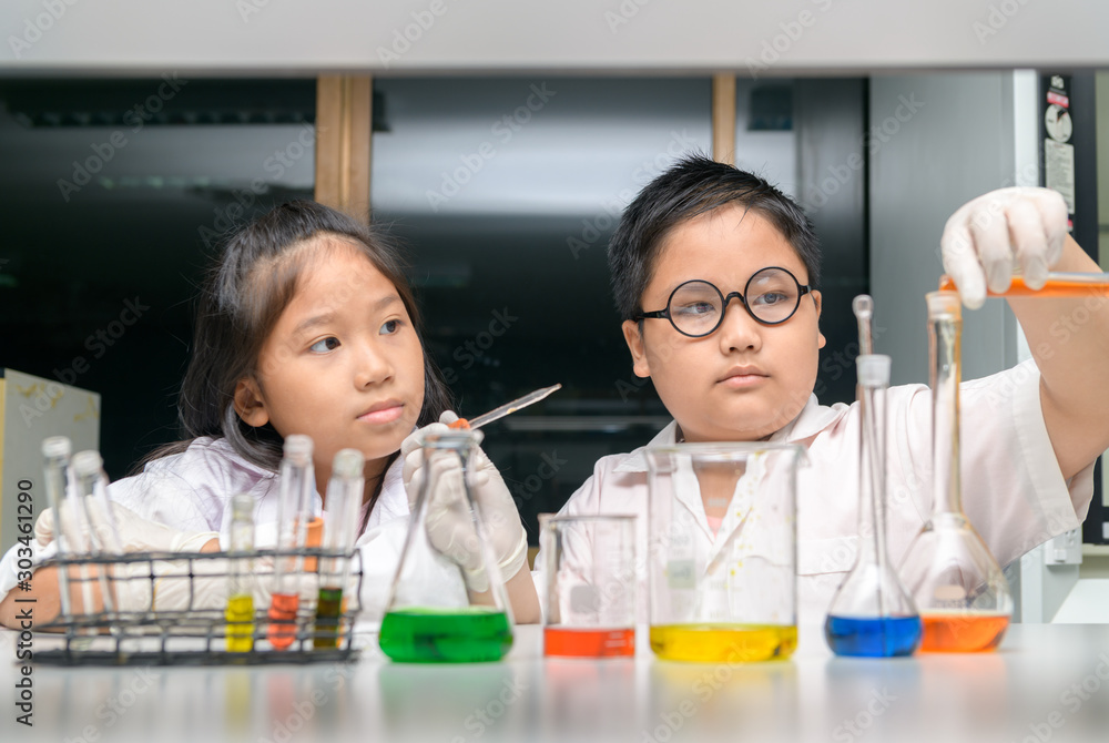 Happy two children making science experiments. Happy two children making science experiments.