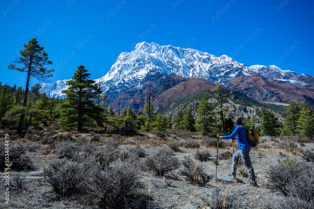 Man standing to look at view of snow mountains, travel photography