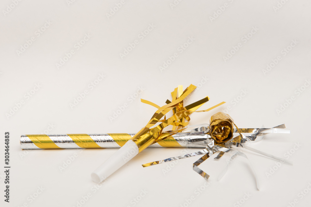 Fotografie Isolated yellow party blowers on white background