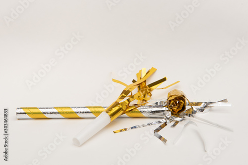 Isolated yellow party blowers on white background