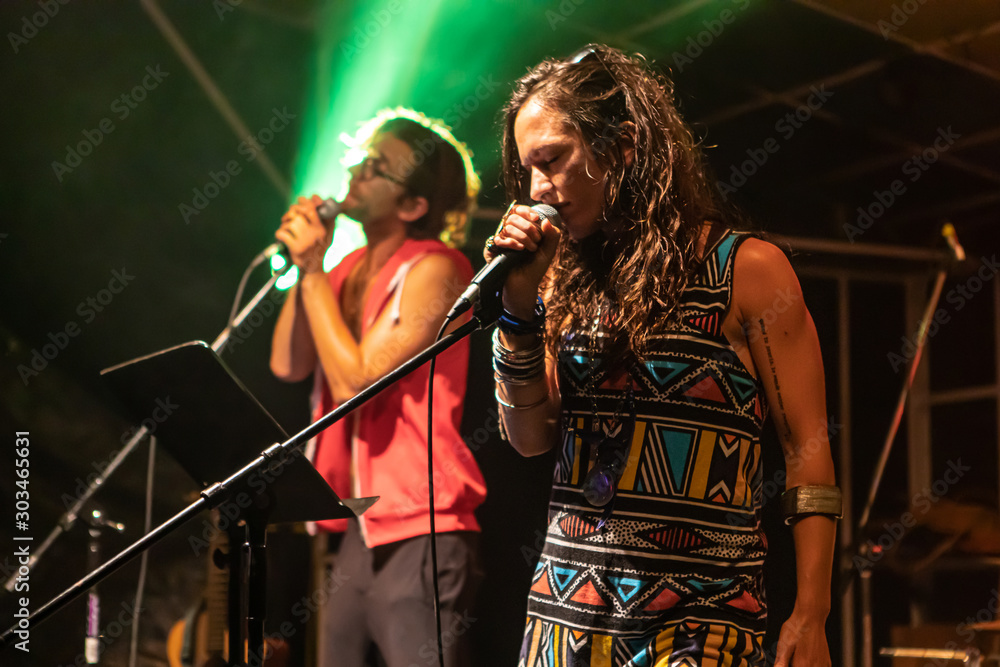 Φωτογραφία a low angle and close up of woman and man as they singing and on the stage, male