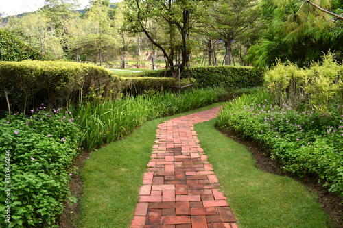 Red walk way in green graden