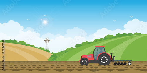 Farmer driving a tractor in farmed land on rural farm landscape hill background.
