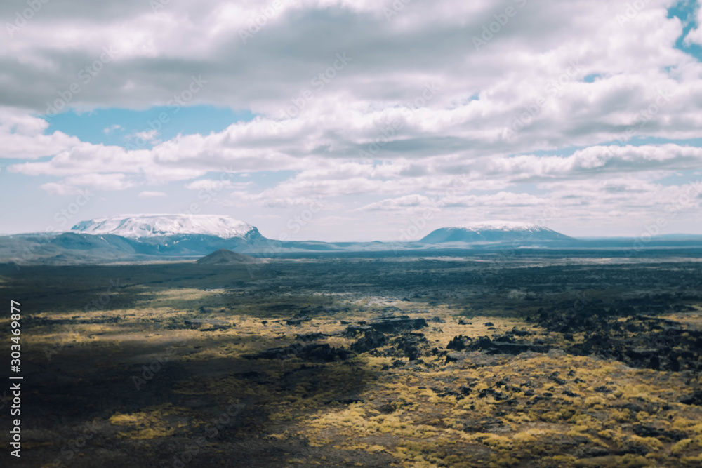 View of Hverfjall lava field near Myvatn, Iceland in the summer with volcanos in the background