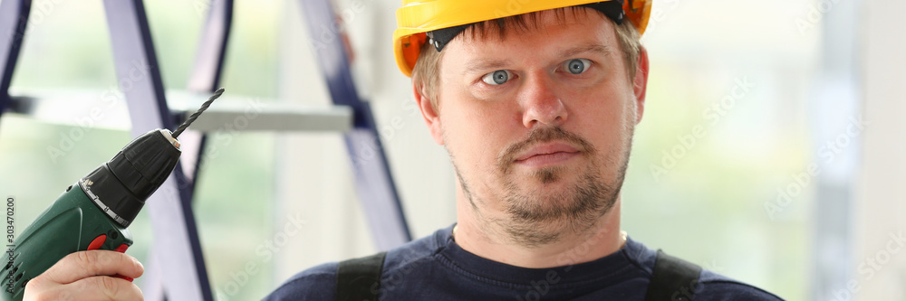 Idiot worker using electric drill portrait Idiot worker using electric drill portrait