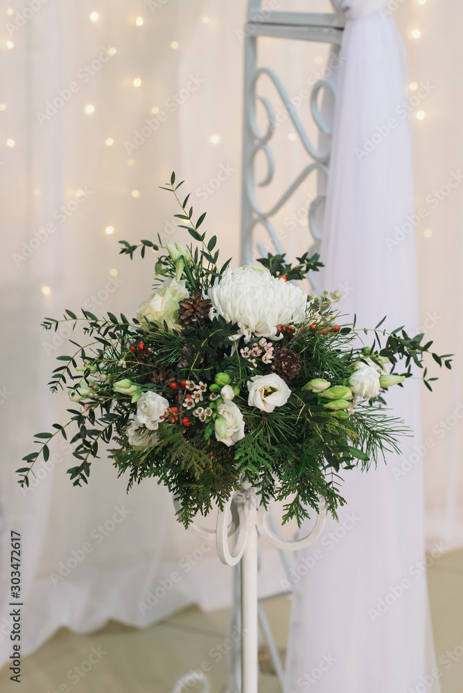 marriage flower arrangement with chrysanthemum, pine branches and cones, eustoma, ilex, thuja, waxflover, Eucalyptus parvifolia, freesia on high stand on floor for winter wedding indoors, stock photo marriage flower arrangement with chrysanthemum, pine branches and cones, eustoma, ilex, thuja, waxflover, Eucalyptus parvifolia, freesia on high stand on floor for winter wedding indoors, stock photo