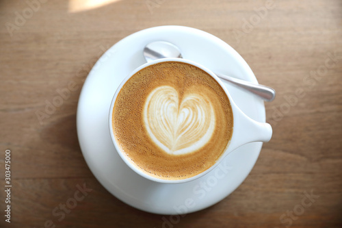 cappuccino or Latte art coffee made from milk on the wood table in coffee shop photo