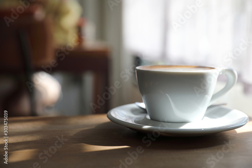 cappuccino or Latte art coffee made from milk on the wood table in coffee shop