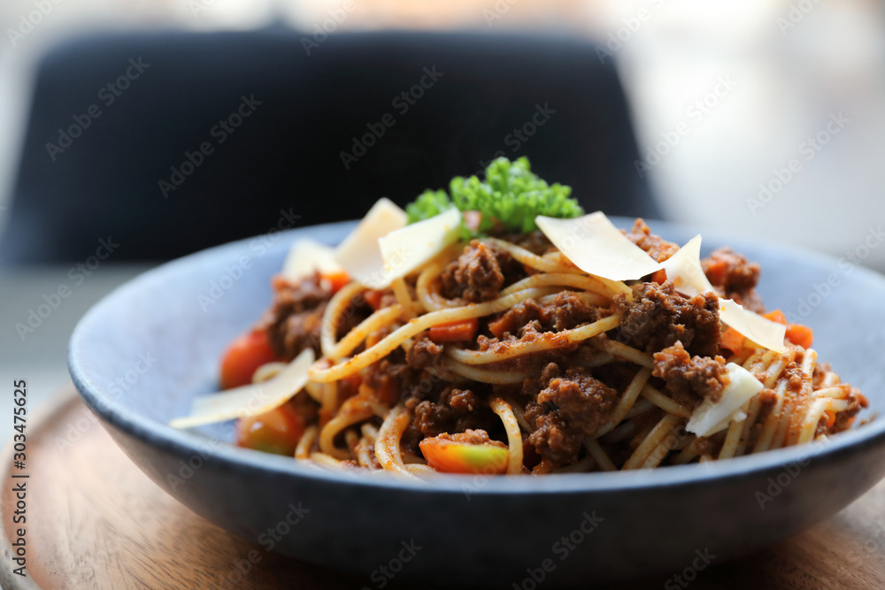 spaghetti Bolognese with minced beef and tomato sauce garnished with parmesan cheese and basil , Italian food spaghetti Bolognese with minced beef and tomato sauce garnished with parmesan cheese and basil , Italian food