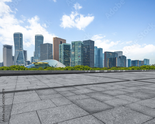 empty square and city skyline under blue sky, hangzhou city, china.