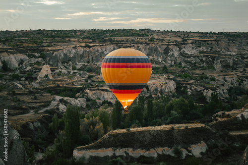 Hot air balloon flying over Cappadocia at dawn