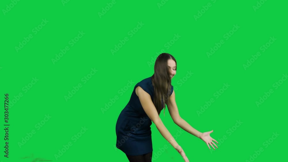 Happy excited girl pointing promoting in front of the green screen Happy excited girl pointing promoting in front of the green screen