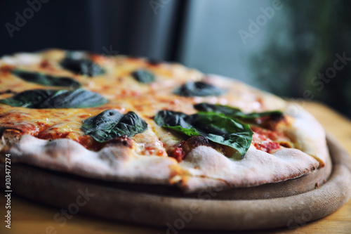 pizza margherita , Italian Pizza with Tomatoes , Basil and Mozzarella Cheese on wood background