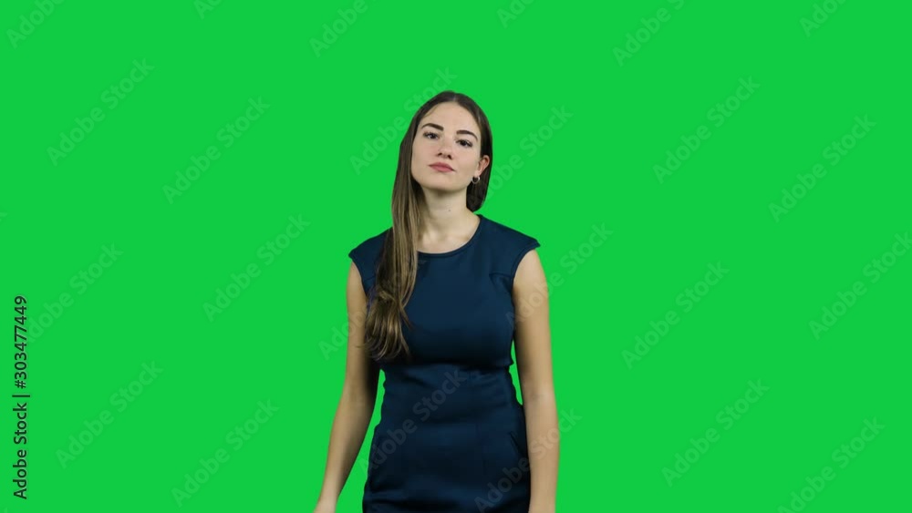 Girl usees a TV remote in front of a green screen Girl usees a TV remote in front of a green screen