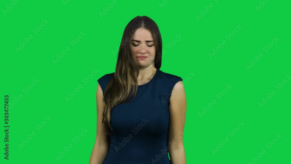 Girl smelling disgusting smells in front of a green screen Girl smelling disgusting smells in front of a green screen