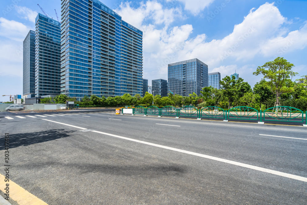 empty asphalt road front of modern buildings. empty asphalt road front of modern buildings.