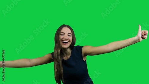 Sexy attractive girl cheering in front of a green screen photo