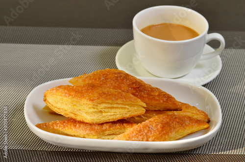 Sugar puff pastry or sugar khari with a cup of tea photo