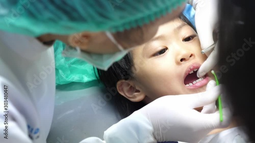 dentish check teeth asian girl in clinic. dental child concept. photo