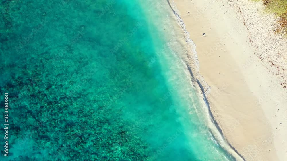 Beautiful sea texture of seabed lagoon with rocks and corals, waving over fine white sand of tropical beach in Bahamas Beautiful sea texture of seabed lagoon with rocks and corals, waving over fine white sand of tropical beach in Bahamas
