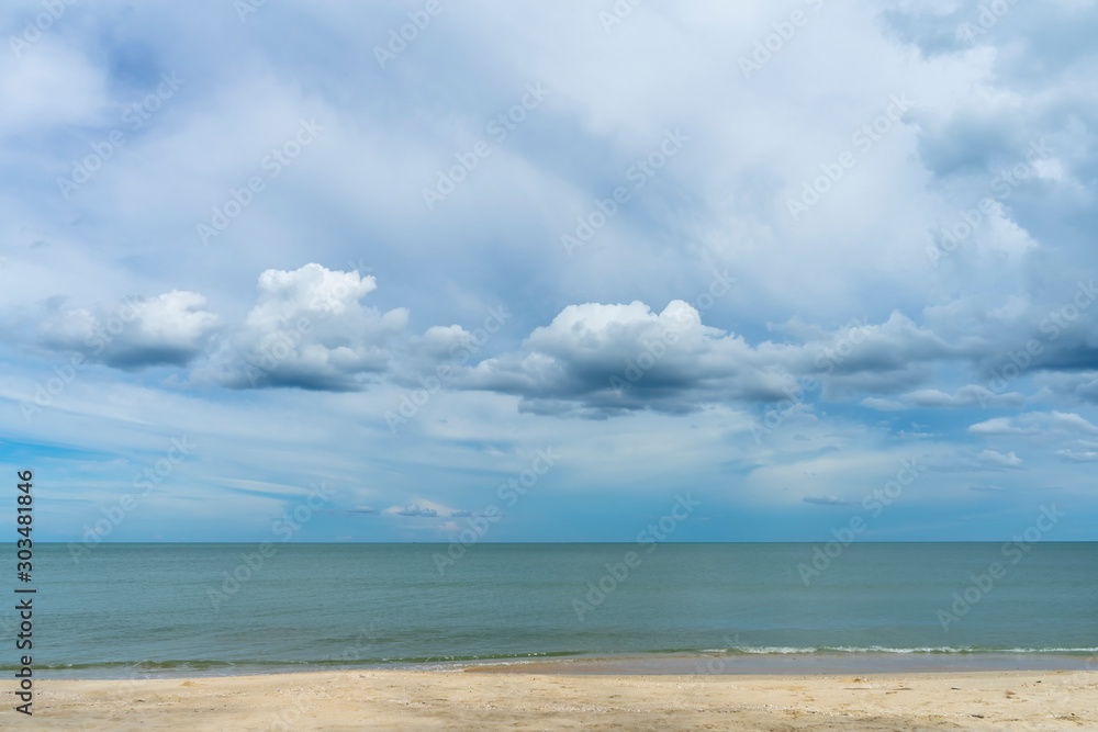 Nobody on the beach with blue sky and clouds in rain season.