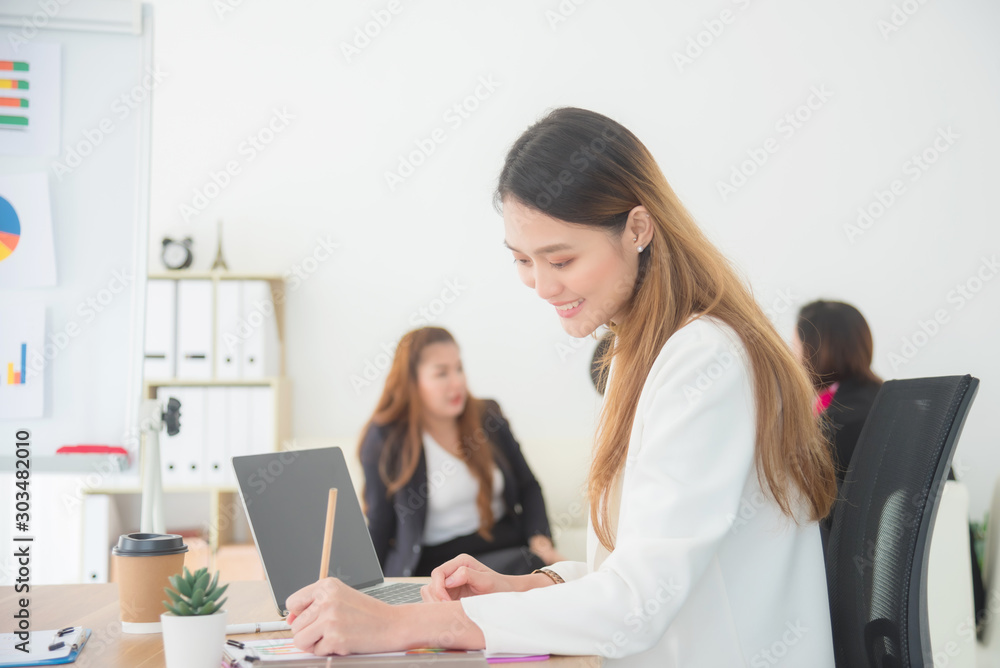 Beautiful asian businesswoman working in office,Female director working in office sitting at desk and analyzing business statistics. Beautiful asian businesswoman working in office,Female director working in office sitting at desk and analyzing business statistics.