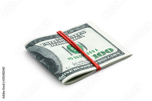 Obraz na plátně Side view of several hundred dollar bills folded in half tied with an elastic band for money isolated on a white background