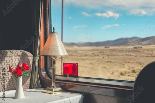 The luxury wooden decoration with comfortable sofas and fancy table lamps  of the Perurail Titicaca train. It is from Cusco across the Altiplano to Puno and Lake Titicaca in southern Peru. photo