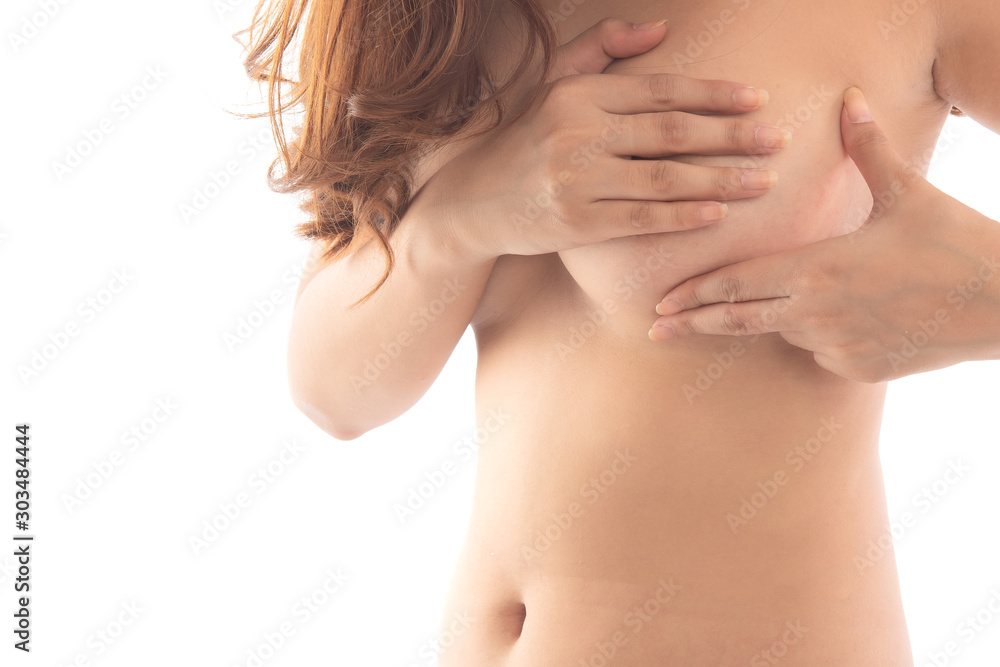 Closeup cropped portrait young woman with breast pain touching chest isolated on white background free from copy space. Woman hand checking lumps on her breast for breast cancer. Closeup cropped portrait young woman with breast pain touching chest isolated on white background free from copy space. Woman hand checking lumps on her breast for breast cancer.