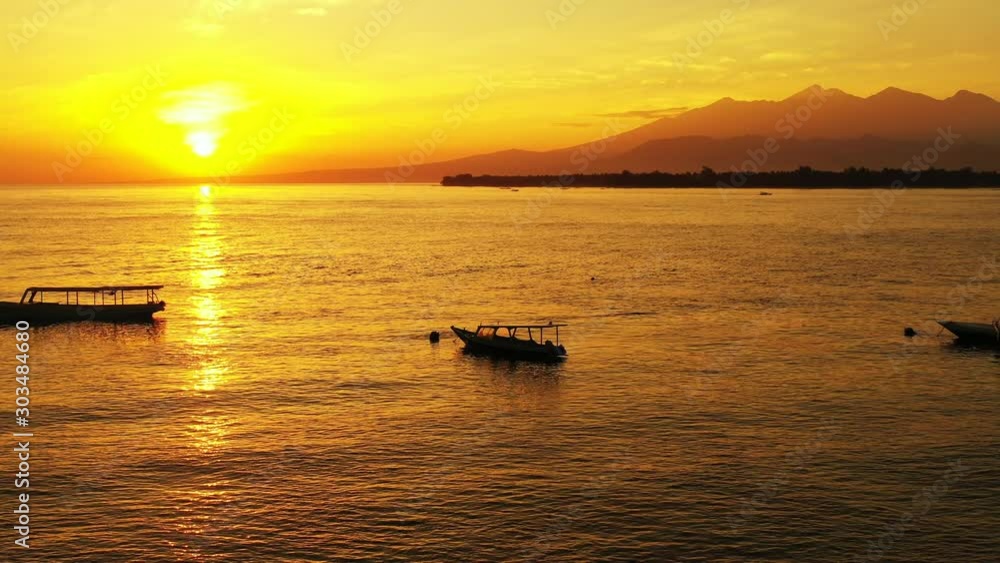Wide Shot Of Sunset By The Island Of Bahamas With Mountain Stretch and Boats On The Background Wide Shot Of Sunset By The Island Of Bahamas With Mountain Stretch and Boats On The Background