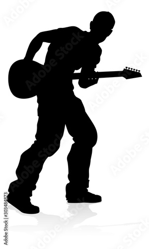 A guitarist musician in detailed silhouette playing his guitar musical instrument.