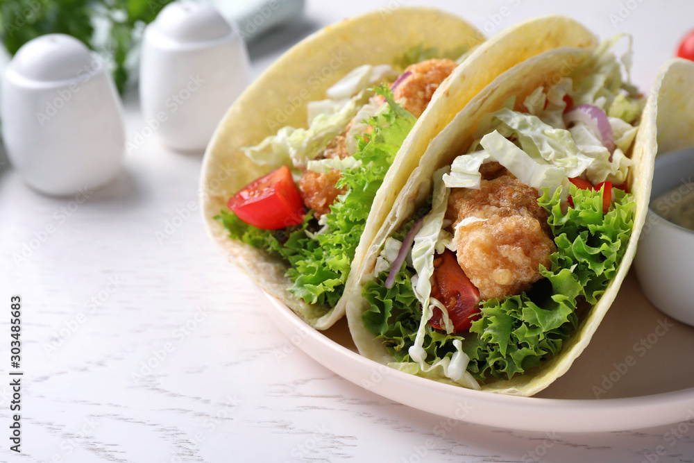 Yummy fish tacos served on white wooden table, closeup Yummy fish tacos served on white wooden table, closeup