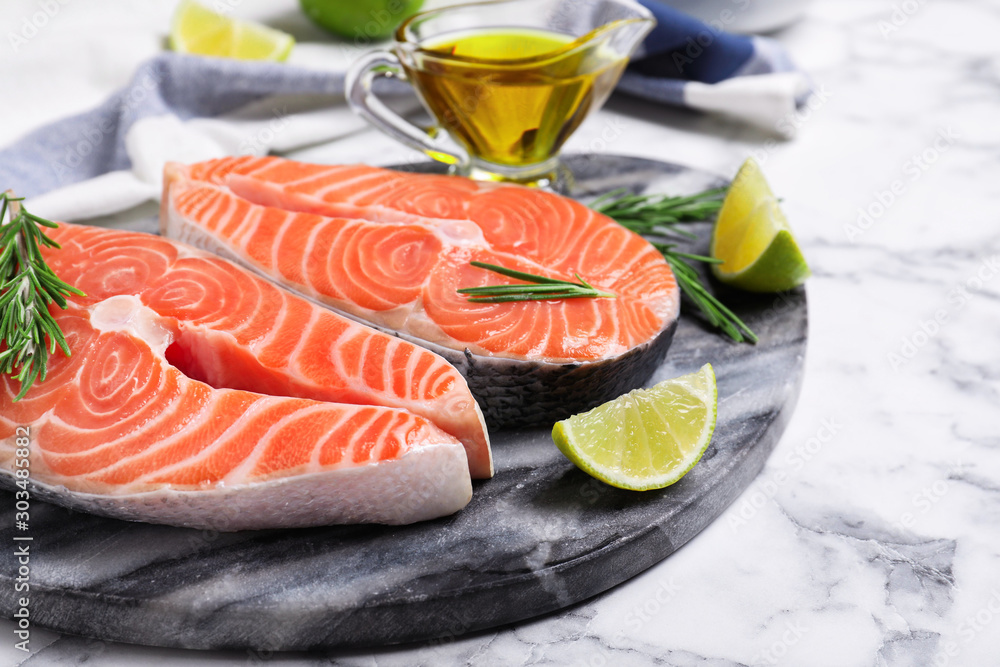 Fresh raw salmon with rosemary and lime on stone board. Fish delicacy Stock  사진 | Adobe Stock