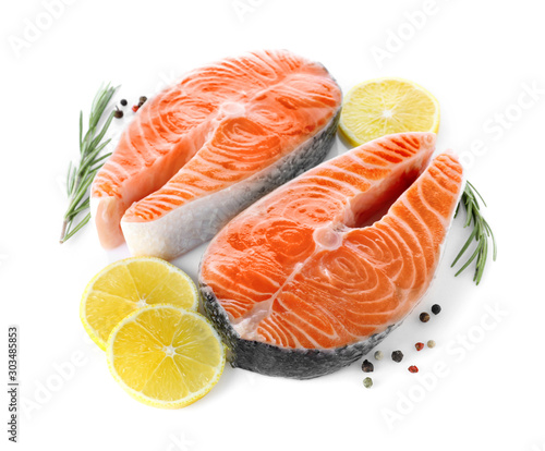 Fresh raw salmon with lemon, pepper and rosemary on white background. Fish delicacy