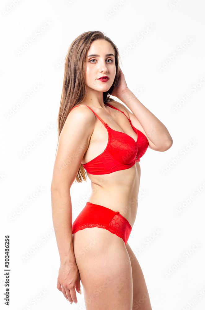 Obraz premium Beautiful, sexy, elegant blonde woman in red lingerie on a white background