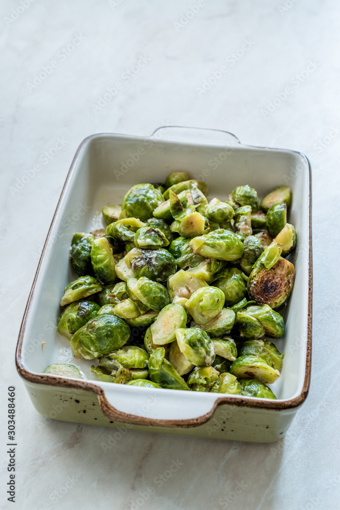 Homemade Roasted Brussel Sprouts in Porcelain Bowl. Homemade Roasted Brussel Sprouts in Porcelain Bowl.