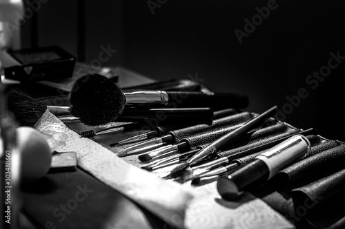 Makeup artist brushes on the table in black and white photo