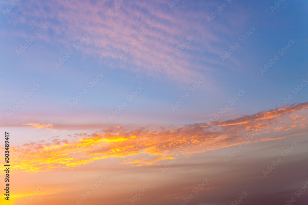 Golden clouds at sunset on the blue sky Golden clouds at sunset on the blue sky
