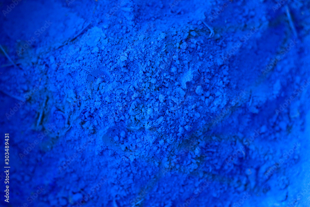 Blue powder texture close up. Cloth whitener indigo.