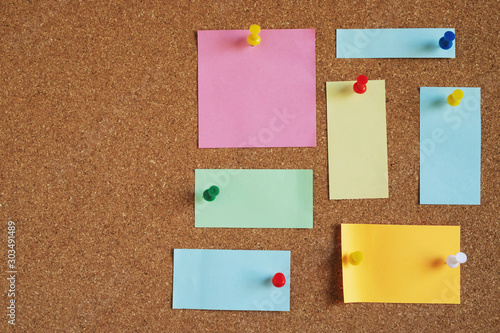 collection of colorful variety post. paper note reminder sticky notes pin on cork bulletin board. empty space for text. photo