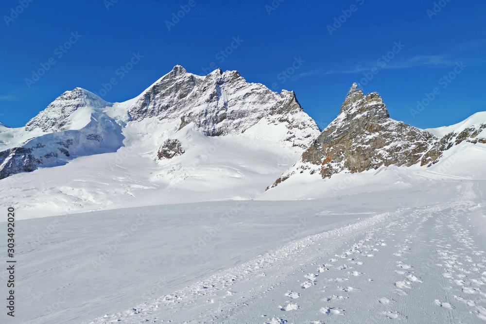 Peak of Switzerland Grindelawld snow mountain with cloud and wooden house Peak of Switzerland Grindelawld snow mountain with cloud and wooden house