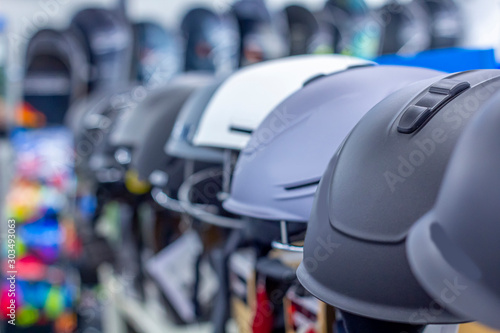 Row of helmets for skateboarding at the shop (showroom or store). Shopping and season sale concept. Sports Accessories.