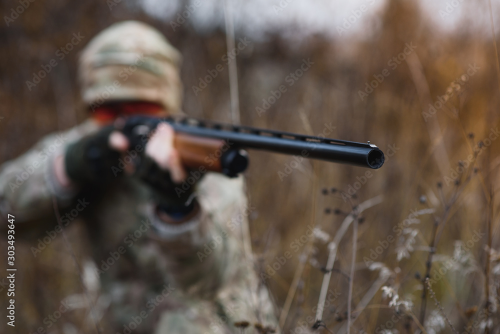 Fototapeta premium The hunter takes aim at the wild beast in the forest. Hunting concept