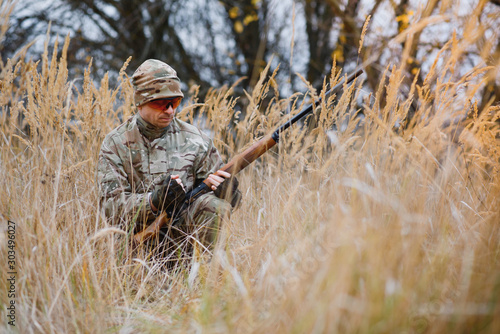 Hunting permit. Man brutal gamekeeper nature background. hunter spend leisure hunting. Hunter hold riffles. Focus and concentration of experienced hunter. Hunting and trapping seasons.