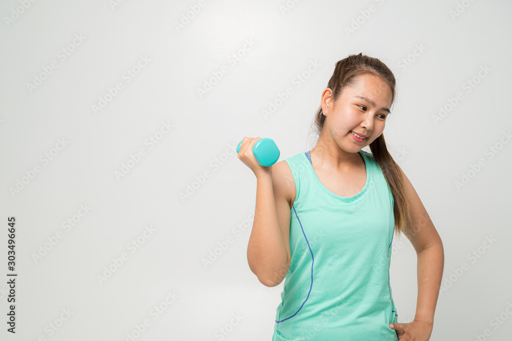 Portrait of a young woman with Green gym clothes and holding weights and doing fitness on a white background. Portrait of a young woman with Green gym clothes and holding weights and doing fitness on a white background.