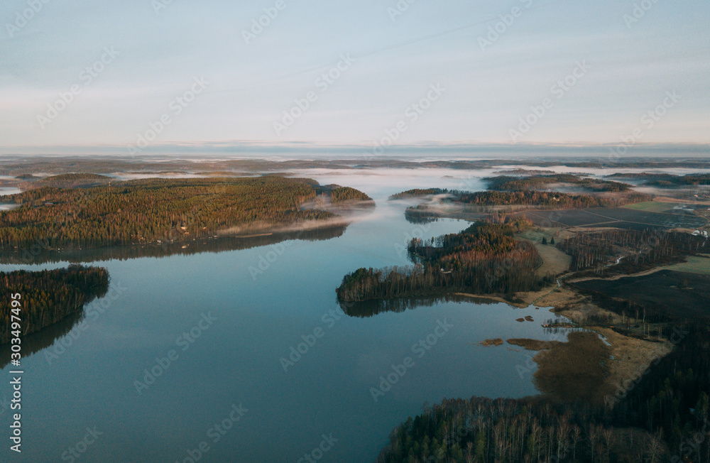Beautiful landscape of a foggy lake. Aerial view at autumn lake landscape in Finland