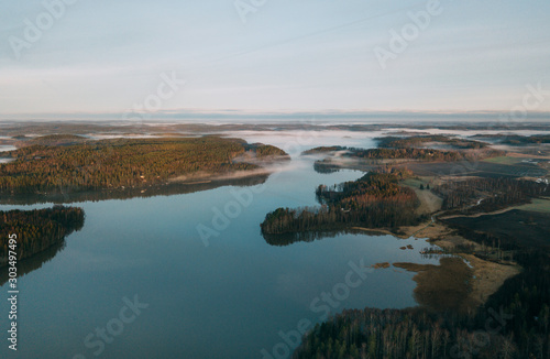 Beautiful landscape of a foggy lake. Aerial view at autumn lake landscape in Finland © kriina2000