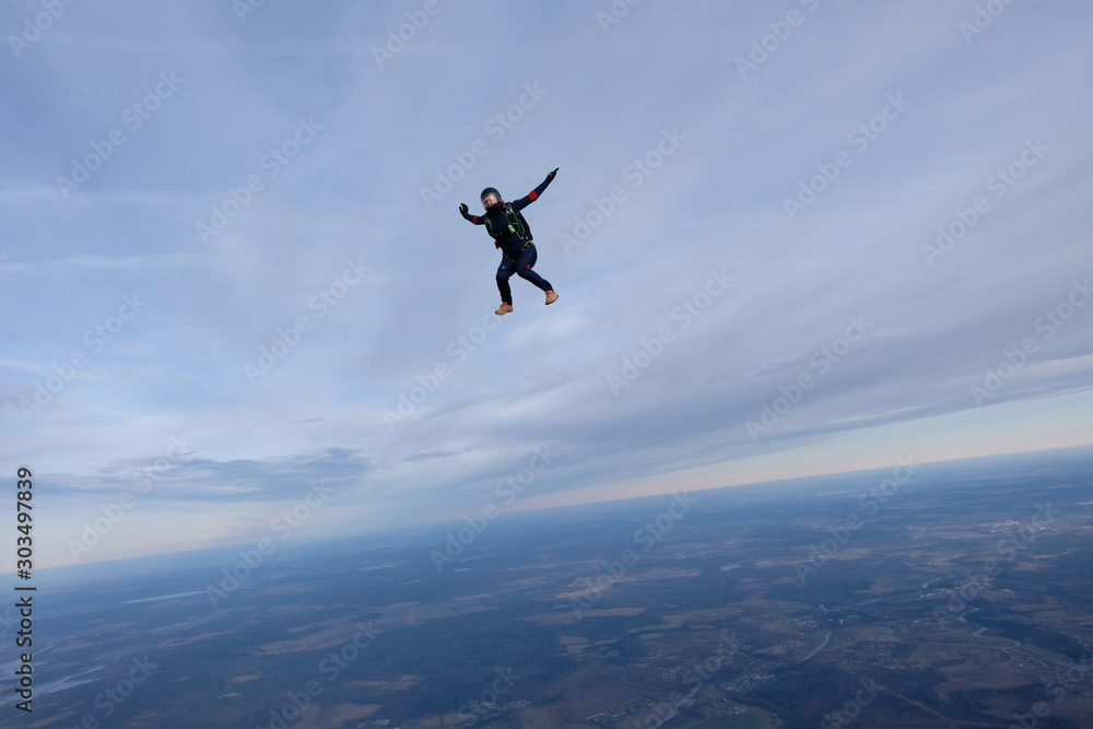 Skydiving. A solo skydiver is flying in the sky