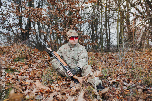 Hunting permit. Bearded hunter spend leisure hunting. Hunting equipment for professionals. Hunting is brutal masculine hobby. Man aiming target nature background. Hunter hold rifle. Aiming skills.